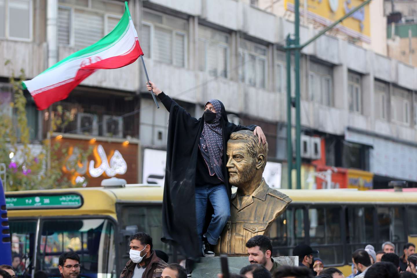 People celebrate after Iran's win against Wales