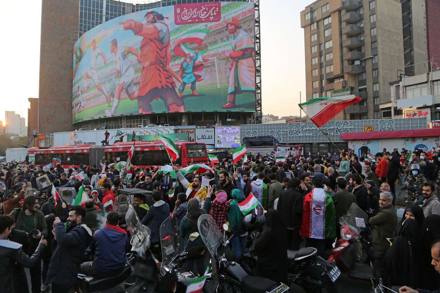 People celebrate after Iran's win against Wales