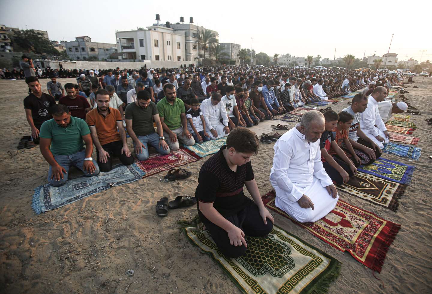 Palestinian Muslims perform Eid al-Adha prayers in a "yard"