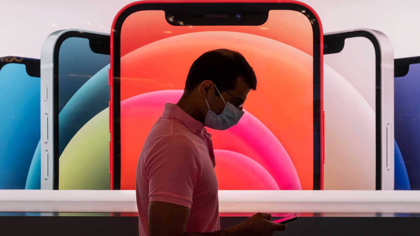 A customer queues in line at an Apple store during the