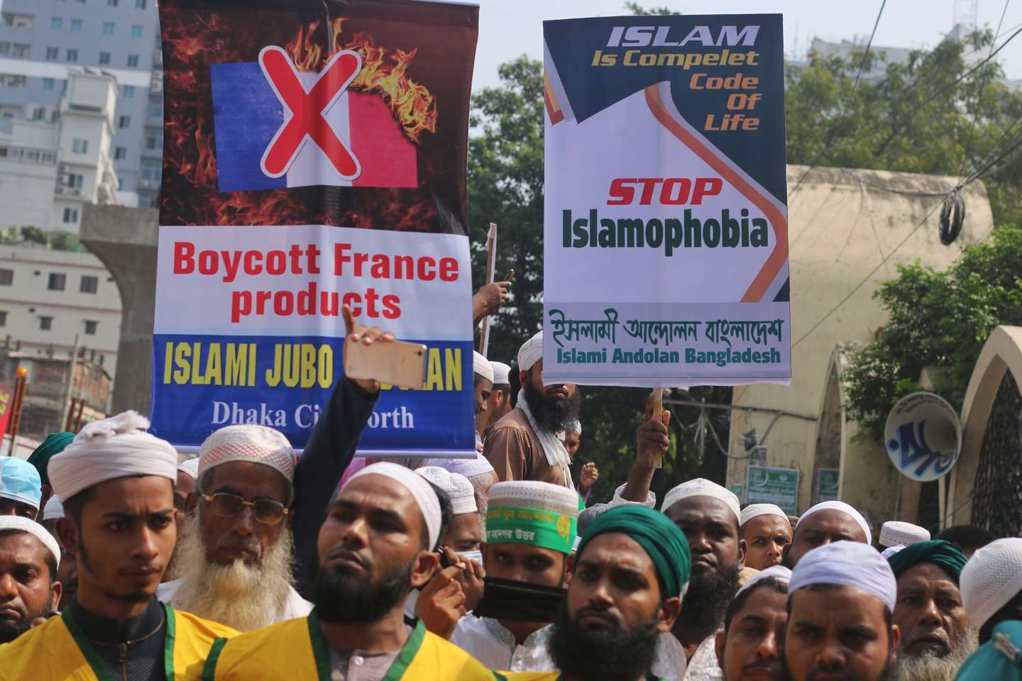 Muslim protesters display placards during the protest in