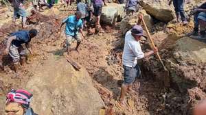 epa11373826 A handout photo made available by the International Organzation for Migration (IOM), shows local inhabitants digging in the rubble using spades and wooden sicks to serach for missing relatives at the landslide site in Tuliparo village, Yambali Ward, Maip Muli LLG, Porgera District,Papua New Guinea, 26 May 2024. (Issued 27 may 2024). According to a senior official with the IOM, on 26 May, more than 670 people are feared dead, after a landslide hit the Higlands region of Papua New Guinea on early 24 May. &quot; the community in Yambali village, situated at the foot of a mountain in the remote Enga Province, is buried under between six to eight metres of soil. 150 houses are believed to be buried&quot; he added.  EPA/MOHAMUD OMER/IOM/ HANDOUT  HANDOUT EDITORIAL USE ONLY/NO SALES HANDOUT EDITORIAL USE ONLY/NO SALES