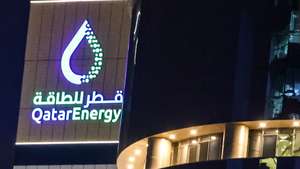 epa12789592 The logo of QatarEnergy is seen in Doha, Qatar, 02 March 2026. QatarEnergy has halted production of liquefied natural gas (LNG) and related products due to military attacks on its facilities in Ras Laffan Industrial City and Mesaieed Industrial City.  EPA/HANNIBAL HANSCHKE