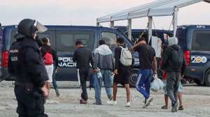 epa13295934 A Spanish National Police officer monitors the clearing of a migrant camp set up in the esplanade in front of the old El Guano factory in Ceuta, Spain, 11 October 2026. Police carried out the new operation just over 48 hours before an official visit by the Spanish royal couple to the Spanish enclave in North Africa.  EPA/Reduan BEST QUALITY AVAILABLE