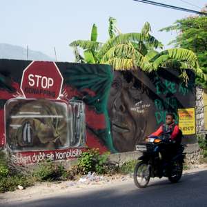 epa13195843 Motorcyclists ride past a mural in Port-au-Prince, Haiti, 27 August 2026. Haiti is preparing to hold elections in December, despite ongoing violence, including an attack on 24 August that killed at least 47 people, amid a wave of violence that claimed more than 3,000 lives in the first six months of the year, according to UN data.  EPA/Jonet St Elois