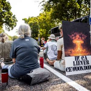 epa13148325 Demonstrators take part in a silent si-in blockade at the main gate of Volkel military air base in Volkel, Netherlands, 03 August 2026. The demonstrators block the entrance to commemorate the atomic bombs dropped on Hiroshima and Nagasaki 81 years ago and to and to protest against the presence of nuclear weapons at the base.  EPA/ROB ENGELAAR