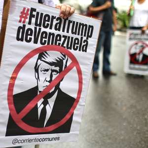 epa13246460 People hold signs bearing a crossed-out image of U.S. President Donald Trump during a march against the oil agreement between Venezuela and the United States in Caracas, Venezuela, 17 September 2026.  EPA/MIGUEL GUTIERREZ