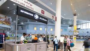 epa09542802 Passengers walk at departure gate at Kuwait international airport in Kuwait City, Kuwait, 24 October 2021. Kuwait resumed full operations of Kuwait International Airport as of 24 October as the country is further easing covid-19 restrictions.  EPA/NOUFAL IBRAHIM