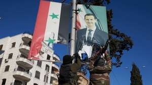 epa11750340 Syrian opposition fighters tear up a portrait of Syrian President Bashar al-Assad in central Aleppo, Syria, 30 November 2024. Syrian opposition forces have taken significant control of Aleppo, a major city and former economic hub of Syria, after intense battles with government forces. The offensive triggered Russian strikes on Aleppo 30 November 2024, the first since 2016, and saw Syria's military withdraw its troops from the city. The attack was led by the Islamist militant group Hayat Tahrir al-Sham (HTS).  EPA/KARAM AL-MASRI