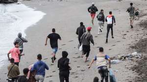 epa13269887 Immigrants run away form the National policemen that are dismantling the migrant camp at Playa Benitez in Ceuta, Spain, 29 September 2026. Spain is dealing with a massive migration crisis in the autonomous region of Ceuta after thousands of people crossed into the North African enclave from Morocco in late July 2026.  EPA/Reduan
