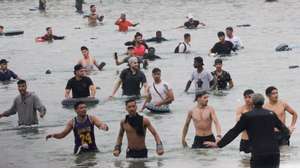 epa13143412 A group of migrants remains on the beach near the Tarajal border crossing in Ceuta, Spain, 31 July 2026. Violent clashes occurred along the border perimeter as migrants attempted to enter Ceuta and Melilla from Morocco.  EPA/REDUAN DRIS