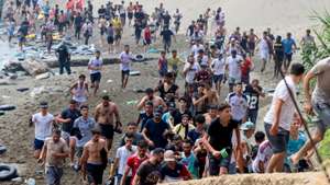 epa13141875 Migrants reach Spanish territory after swimming from Morocco to Ceuta, a Spanish enclave in North Africa, 30 July 2026. Hundreds of migrants swam to cross the border to Ceuta over the last nine days, mainly Moroccan and Algerian. Ceuta officials asked the Spanish government to declare a 'national emergency.'  EPA/Reduan Dris BEST QUALITY AVAILABLE