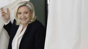 epa09906123 French far-right Rassemblement National (RN) party candidate for the French presidential election Marine Le Pen  leaves the voting booth at a polling station for the second round of the French presidential elections in Henin-Beaumont, France, 24 April 2022.  EPA/Ian Langsdon