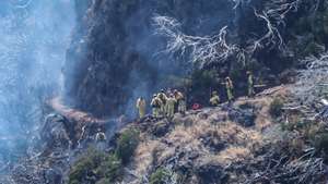 Firefighters battle the flames at Pico Ruivo, the highest point on Madeira Island, in the municipality of Santana, 21 August 2024. The rural fire on the island of Madeira broke out a week ago, on 14 August, in the mountains of the municipality of Ribeira Brava, gradually spreading to the municipalities of Câmara de Lobos, Ponta do Sol and, through Pico Ruivo, Santana. HOMEM DE GOUVEIA/LUSA