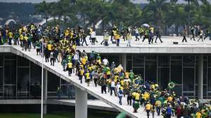 epa10396233 Bolsonaro supporters storm the National Congress in Brasilia, Brazil, 08 January 2023. Hundreds of supporters of former Brazilian President Jair Bolsonaro invaded the headquarters of the National Congress, and also Supreme Court and the Planalto Palace, seat of the Presidency of the Republic, in a demonstration calling for a military intervention to overthrow President Luiz Inacio Lula da Silva. The crowd broke through the cordons of security forces and forced their way to the roof of the buildings of the Chamber of Deputies and the Senate, and some entered inside the legislative headquarters.  EPA/ANDRE BORGES