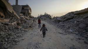 epa12503260 Palestinian children walk between the rubble of destroyed buildings in Jabaliya northern Gaza Strip, 04 Nove,ber 2025, amid a ceasefire between Israel and Hamas. Following Israeli claims that Hamas violated the ceasefire, Prime Minister Netanyahu ordered military strikes on the Gaza Strip on 28 October. In response, Hamas announced it was postponing the planned handover of a recovered hostage's body, citing Israeli truce violations.  EPA/MOHAMMED SABER