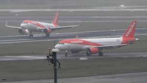 epa08788228 An EasyJet plane (L) lands during the opening of BER Berlin Brandenburg Airport in Schoenefeld, Germany, 31 October 2020. The opening of BER airport on 31 October 2020 is planned with the arrival of two first passenger planes by companies Lufthansa and EasyJet.  EPA/CLEMENS BILAN