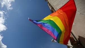epa11499810 The Royal Liver Building behind a pride flag during the annual Pride march in Liverpool, Britain, 27 July 2024. Liverpool Pride is an annual celebration of LGBT+ culture attracting around 75,000 participants, making it one of the largest Pride event in Europe.  EPA/ADAM VAUGHAN