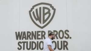 epa12471315 A person walks by the Warners Bros. studio tour location at the Warner Bros. Studio Lot in Burbank, California, USA, 21 October 2025. Warner Bros. Discovery revealed in a press release on 21 October that it is putting the company up for sale.  EPA/CAROLINE BREHMAN