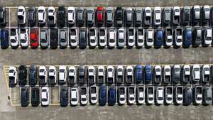 epa10715894 An aerial view shows a segment of the courtyard of the Volkswagen car factory, with thousands of stopped vehicles, in the city of Sao Bernardo do Campo, Brazil, 28 June 2023. The German company Volkswagen announced a temporary suspension of production in its factories in Brazil as a result of the 'market stagnation' of the sale of vehicles, according to the company.  EPA/ISAAC FONTANA