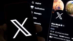 epa10772473 An illustration pictures shows a user holding a mobile phone displaying the 'X' logo in front of Elon Musk's page in Los Angeles, California, USA, 27 July 2023. Twitter announced on 23 July that it will rebrand to X.  EPA/ETIENNE LAURENT