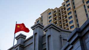 epa11111852 (FILE) - China's national flag flutters next to an Evergrande housing complex in Beijing, China, 27 January 2024 (reissued 29 January 2024). A Hong Kong court ordered China Evergrande Group on 29 January 2024 to liquidate, after the real estate company with debts of over 300 billion dollars, failed to reach an agreement on debt restructuring with its overseas creditors.  EPA/MARK R. CRISTINO