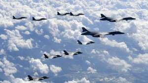 epa06211837 A handout photo made available by the South Korea Defense Ministry on 18 September 2017 shows South Korean F-15K combat planes (background, L), U.S. Air Force B-1B bomber planes (top, R) and F-35B combat planes (bottom, L) flying in the sky over South Korea while being on a bombing drill mission to hit simulated targets at the Pilseung Range in Gangwon-do, in South Korea, 18 September 2017.  EPA/South Korea Defense Ministry / HANDOUT  HANDOUT EDITORIAL USE ONLY/NO SALES