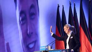 epa11852370 Alternative for Germany (AfD) party and faction co-chairwoman and top candidate for the federal election Alice Weidel talks online to Elon Musk during her speech during election campaign launch in Halle, Germany, 25 January 2025. Germany will hold early federal elections on 23 February 2025.  EPA/HANNIBAL HANSCHKE
