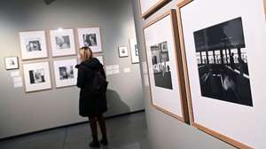 epa09738733 A visitor looks at photographs by Vivian Maier during a preview of the exhibition 'Unpublished Vivian Maier' in Turin, Italy, 08 February 2022. The exhibition of works and personal items of the US photographer can be seen from 09 February to 26 June 2022 at the Musei Reali di Torino in Turin.  EPA/ALESSANDRO DI MARCO