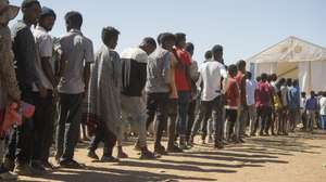 epaselect epa08858053 Ethiopian refugees from Tigray region wait in line to receive aid at the Um Rakuba refugee camp, the same camp that hosted Ethiopian refugees during the famine in the 1980s, some 80 kilometres from the Ethiopian-Sudan border in Sudan, 30 November 2020 (issued 02 December 2020). According to World Food Programme on 02 December, about 12,000 Ethiopian refugees from Tigray are accommodated in the Um Rakuba camp as over 40,000 Ethiopian refugees fled to Sudan since the start of fights in the northern Tigray region of Ethiopia. Ethiopia's military intervention   comes after Tigray People's Liberation Front (TPLF) forces allegedly attacked an army base on 03 November 2020 sparking weeks of unrest. According to reports on 02 December 2020, UN reached an agreement with Ethiopian government to provide aid for the Tigray region of Ethiopia.  EPA/ALA KHEIR