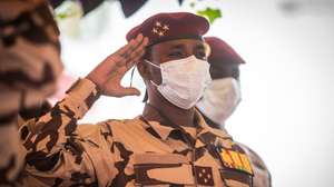 epa09155825 Son of the late Chadian president Idriss Deby, Mahamat Idriss Deby (C) pays his military respects at the coffin of the late Chadian president Idriss Deby during the state funeral in N'Djamena, Chad, 23 April 2021. Chad's President Idriss Deby died of injuries suffered in clashes with rebels in the country's north, an army spokesperson announced on state television on 20 April 2021. Deby had been in power since 1990 and was re-elected for a sixth term in the 11 April 2021 elections. The state funeral took place on the morning of 23 April 2021, attended by French President Emmanuel Macron.  EPA/CHRISTOPHE PETIT TESSON / POOL
