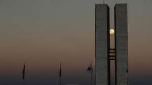 epa09227788 View of the full moon between the two towers of the National Congress building, in Brasilia, Brazil, 25 May 2021.  EPA/Joedson Alves