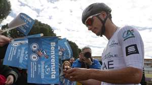 epa10514944 Portuguese rider Joao Almeida of the team UAE Team Emirates signs autographs before the 6th stage of the Tirreno Adriatico cycling race, over 193km from Osimo Stazione to Osimo, Italy, 11 March 2023.  EPA/ROBERTO BETTINI