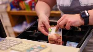 epa10842715 A saleswoman reaches into a cash register and gives change at a store in Essen Germany, Germany, 05 September 2023. According to German government statistics, food prices in July 2023 were on average 11 percent higher compared to the same period in 2022. Various German welfare organizations reported in 2022 that 13.8 million people in Germany lived in poverty or were at risk of being below the poverty line.  EPA/Christopher Neundorf