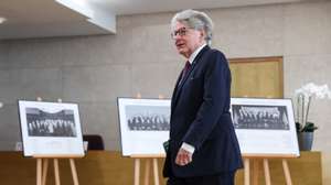 epa11597955 Outgoing Internal Market European Commissioner Thierry Breton walks past historic images of European Commission meetings before the 2500th meeting of the College of Commissioners in Brussels, Belgium, 11 September 2024. The first formal meeting of the European Commission took place in Brussels on 16 January 1958 which was by then the European Economic Community (ECC). It was chaired by Walter Hallstein, President of the Commission of the European Economic Community.  EPA/OLIVIER HOSLET