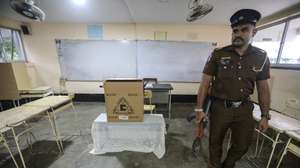 epa11615959 An armored Police officer stands guard at a polling station on the eve of the presidential election in Colombo, Sri Lanka, 20 September 2024. Sri Lanka will hold its presidential election on 21 September 2024, its first elections since mass protests and a political crisis were triggered by an economic collapse in 2022. A total of 39 candidates from recognized political parties and independent groups have submitted their nominations, with incumbent president Ranil Wickremesinghe running for a second term.  EPA/CHAMILA KARUNARATHNE