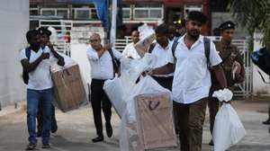 epa11617552 Sri Lankan polling officials carry ballot boxes to submit at a counting center after the end of voting for the presidential election in Colombo, Sri Lanka, 21 September 2024. Nearly 17.1 million registered voters in Sri Lanka were set to participate in the country's first election since mass protests and a significant political crisis, both sparked by the economic collapse of 2022. A total of 39 candidates from recognized political parties and independent groups have filed their nominations, with the current president, Ranil Wickremesinghe, seeking a second term.  EPA/CHAMILA KARUNARATHNE