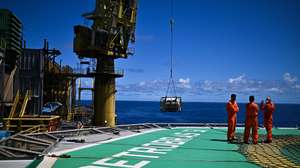 epa11696333 Employees on the P-51 platform of Brazilian oil company Petrobras in the Marlim Sul field, in the Campos Basin, off the northern coast of the State of Rio de Janeiro, Brazil, 31 October 2024 (issued 01 November 2024). Petrobras has launched a revitalization project to extend the life and increase production in the Campos offshore basin, which used to be its largest oil province and is now, just days away from the 50th anniversary of its discovery, considered a mature field.  EPA/Andre Borges