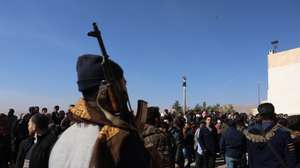 epa11766696 An armed rebel stands guard as Syrians search for relatives they believe were held in secret cells at Sednaya prison, dubbed by Amnesty International as the 'Human Slaughterhouse', near Damascus, Syria, 09 December 2024. The Political Affairs Department of the Syrian Salvation Government said 30,000 prisoners have been released so far from only the first floor of Sednaya prison in Damascus. Rescue efforts continue to find prisoners. Syrian rebels entered Damascus on 08 December 2024 and announced in a televised statement the 'Liberation of the city of Damascus and the overthrow of Bashar al-Assad', as well as the release of all the prisoners.  EPA/MOHAMMED AL RIFAI