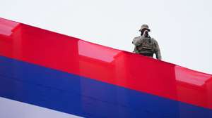 epa11925864 A special police officer observes from a vantage point the rally of support for the President of Republika Srpska Milorad Dodik in Banja Luka, Bosnia and Herzegovina, 26 February 2025. Dodik has been sentenced to one year in prison and barred from public office for six years in a first-instance verdict for disobeying the decisions of Bosnia and Herzegovina’s international envoy, High Representative Christian Schmidt.  EPA/NIDAL SALJIC
