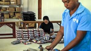 epa08548863 Workers pack ground coffee at a traditional coffee factory in Dili, East Timor, also known as Timor Leste, 16 July 2020. Coffee is one of Timor Leste economy's largest non-oil exports.  EPA/ANTONIO DASIPARU