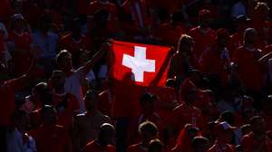 epa11445049 A supporter of Switzerland waves a Swiss flag ahead of the UEFA EURO 2024 Round of 16 soccer match between Switzerland and Italy, in Berlin, Germany, 29 June 2024.  EPA/FILIP SINGER