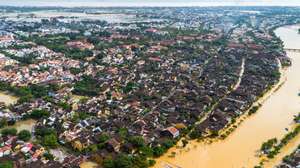 epa12494614 An aerial photo shows flood waters surrounding streets and houses after heavy rain in Hoi An, Vietnam, 31 October 2025. Floods triggered by record rainfall killed at least ten people and left several others missing in central Vietnam, according to state media.  EPA/STRINGER