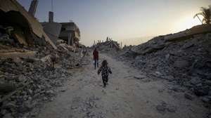epa12503260 Palestinian children walk between the rubble of destroyed buildings in Jabaliya northern Gaza Strip, 04 Nove,ber 2025, amid a ceasefire between Israel and Hamas. Following Israeli claims that Hamas violated the ceasefire, Prime Minister Netanyahu ordered military strikes on the Gaza Strip on 28 October. In response, Hamas announced it was postponing the planned handover of a recovered hostage's body, citing Israeli truce violations.  EPA/MOHAMMED SABER