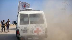epa12514226 Red Cross vehicles transport a body after it was released by the al-Qassam Brigades, the military wing of Hamas, in Deir Al-Balah, central Gaza Strip, 09 November 2025. Hamas claims the body belongs to Israeli soldier Hadar Goldin, who was killed in the 2014 Gaza War. Israel has not yet positively verified the remains.  EPA/HAITHAM IMAD