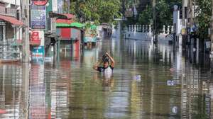 epa12559521 A person wades through a flooded road after heavy rainfall in a suburb of Colombo, Sri Lanka, 30 November 2025. Many parts of the island have been inundated due to heavy rains. According to the Sri Lanka Disaster Management Center, more than 160 people have been killed and about 200 are missing around the country.  EPA/CHAMILA KARUNARATHNE