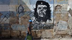 epa12799797 A person walks past a mural depicting Ernesto 'Che' Guevara on a street in Havana, Cuba, 05 March 2026 (issued 06 March 2026). Cuba will experience prolonged power cuts across the country on 06 March 2026, with blackouts that will disconnect up to 68 percent of the island at the time of peak energy demand, a historic high according to data from the state-owned Union Electrica (UNE) compiled by EFE.  EPA/ERNESTO MASTRASCUSA