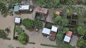 epa12664696 An aerial view shows the flooded 03 February neighbourhood between the Maputo and Gaza regions, Maputo, Mozambique, 20 January 2026. Rescue efforts continue for hundreds of families cut off by flooding, with some taking refuge on rooftops, car roofs, or in treetops in southern Mozambique after days of near-continuous rain that has also forced dams, including some in neighbouring countries, to increase water releases.  EPA/LUISA NHANTUMBO