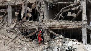 epa12843807 Iranian firefighters and officials work at the site of damaged residential buildings in northern Tehran, Iran, 23 March 2026. A joint Israeli and US military operation continues to target multiple locations across Iran since the early hours of 28 February 2026.  EPA/ABEDIN TAHERKENAREH