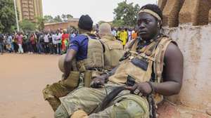 epa10220043 Soldiers sit on a bench during a rally in support of the coup in Ouagadougou, Burkina Faso, 02 October 2022. Thousands of residents came out in support of the coup and protested against France and called for more involvement from Russia. On 01 October, gunshots were heard and the French embassy was set on fire a day after a coup in Ouagadougou. Burkina Faso military Colonel Ibrahim Traore announced on state television 30 September that he had seized power from Lt-Col Paul-Henri Damiba in the coup and alleged Damiba is plotting a counter-attack. In January 2022 Lt-Col Paul-Henri Damiba, ousted President Roch Kabore through a coup.  EPA/ASSANE OUEDRAOGO  EPA-EFE/ASSANE OUEDRAOGO